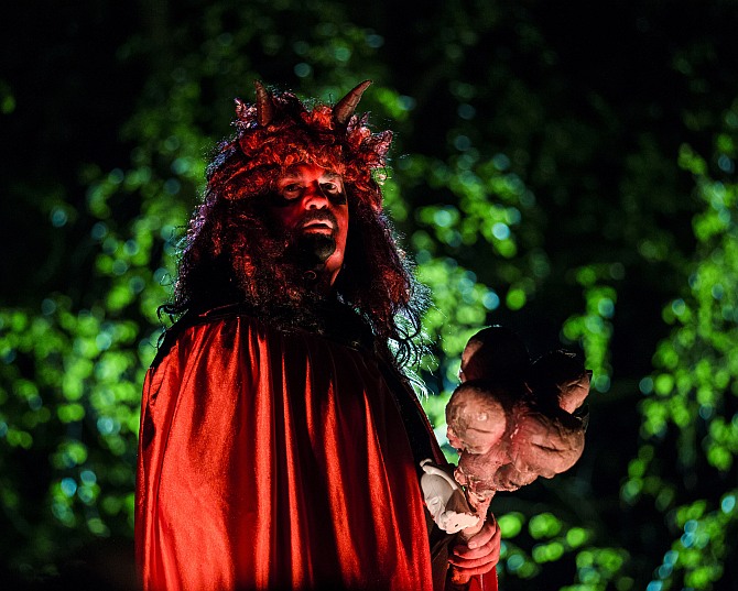 A man dressed as a devil is bathed in red light at a Walpurgisnacht pagan festival in the town of Stiege, in the Harz mountain region