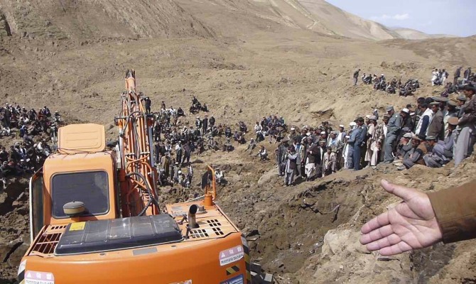 An excavator digs at the site of a landslide at the Argo district in Badakhshan province