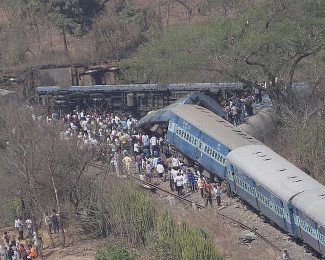 Locals gather around the derailed Diwa-Sawantwadi passenger train