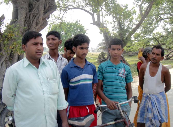 Villagers outside the school area in Gandaman.