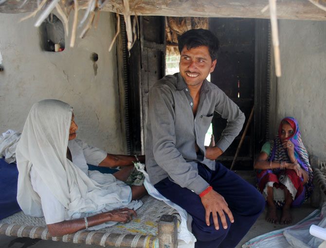 Sonu Singh, a farmer, sits inside his kucchha house. He says he does not have enough money to repair his thatched roof before the rains.