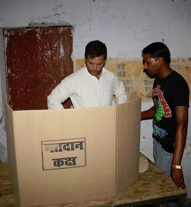 Rahul Gandhi at a poll booth in Amethi with a voter.
