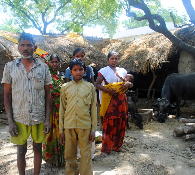 Savitridevi's family with the buffalo she bought with a loan of Rs 30,000 from the Santoshimata Swayam Sahayata Samuh.