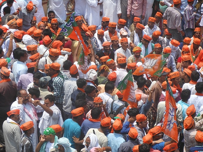 Supporters wave BJP flags as the join the stir