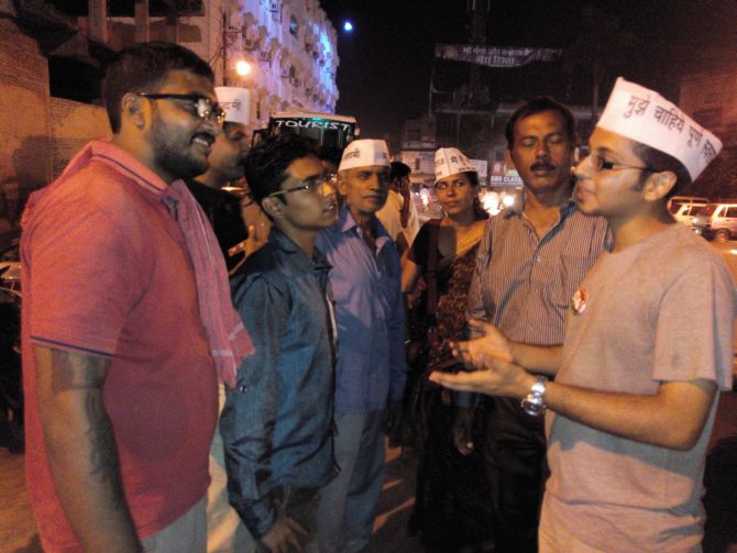 Amish Thakkar, an AAP volunteer, right, spreads the word about the realities of the Gujarat model of development.