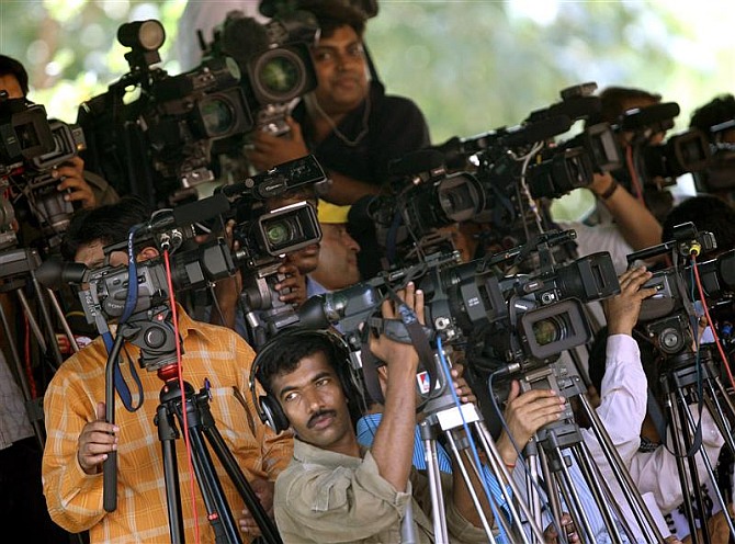 Media persons covering an election rally.