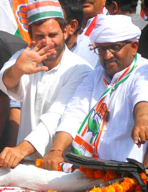 Rahul Gandhi and Congress candidate Ajai Rai wave to supporters during a roadshow in Varanasi on Saturday