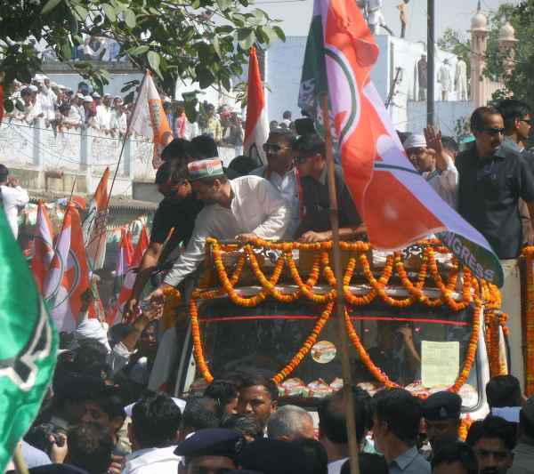 Rahul greets supporters during a roadshow in Varanasi on Saturday