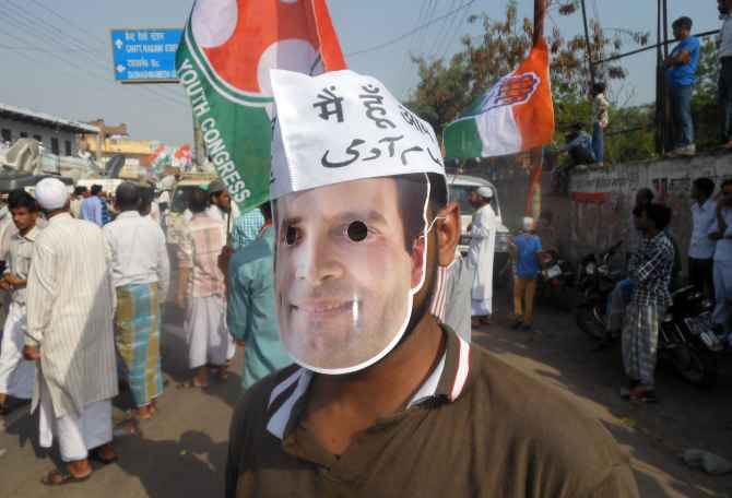 A Congress supporter wears a Rahul Gandhi masks during the roadshow on Saturday