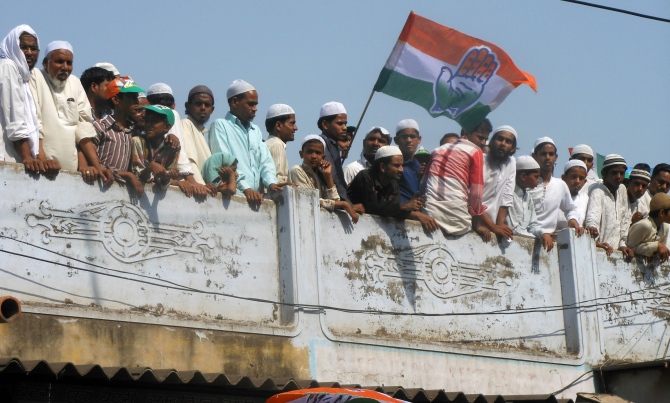 Curious Muslim youth gather on rooftops to take a look at the rally.