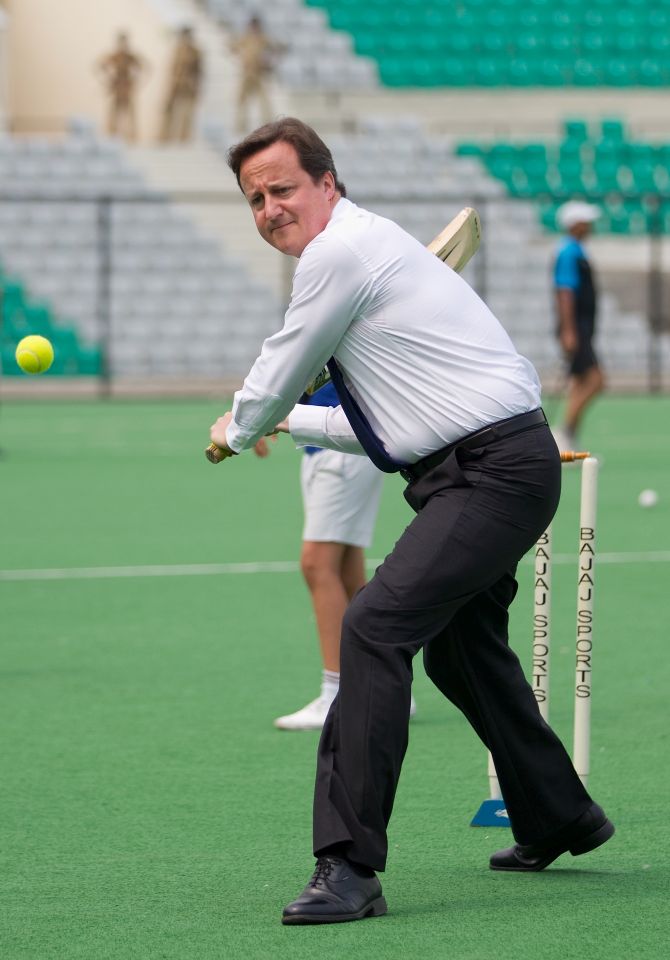 UK PM David Cameron plays cricket during his visit to the country in 2010.