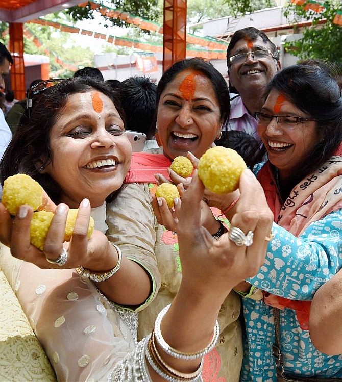 BJP activists celebrate partys victory in Lok Sabha polls, at the partys Delhi Pradesh office in New Delhi on Friday.