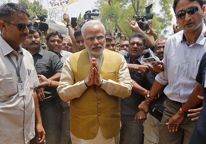 Modi gestures as he arrives to seek blessings from his mother Heeraben at her residence in Gandhinaga