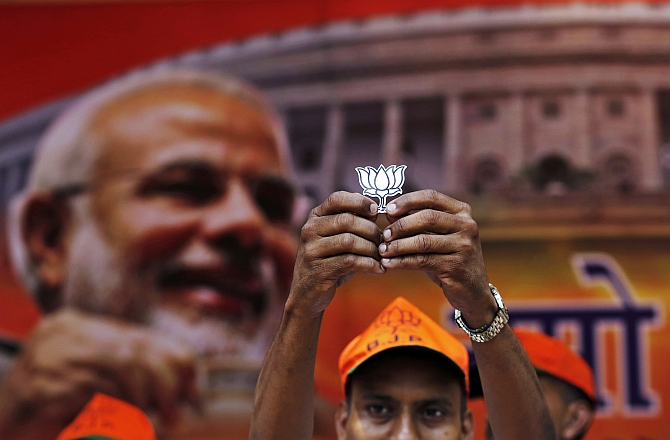 A BJP supporter shows the party symbole, the lotus, in New Delhi