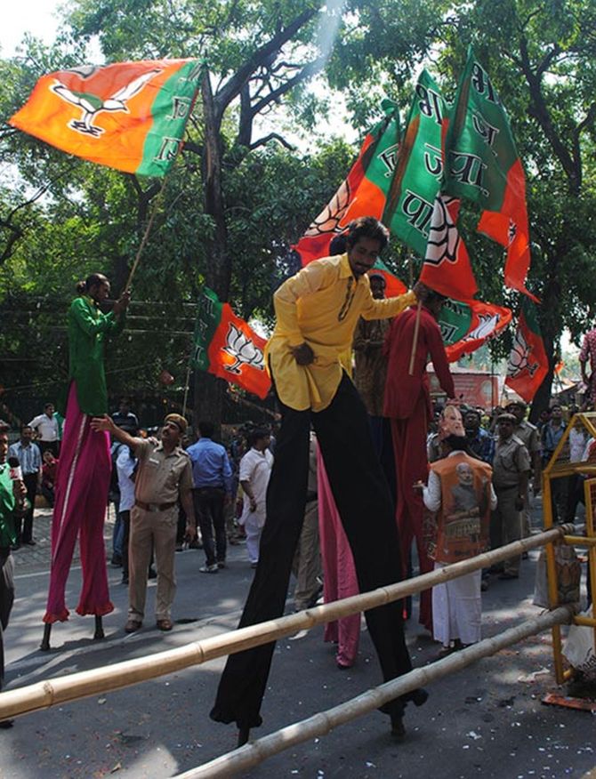 BJP supporters celebrate outside the BJP headquarters. 