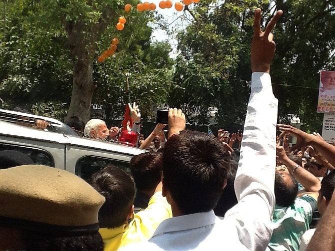 PM-in-waiting Narendra Modi shows a victory sign to his supporters during his roadshow in New Delhi