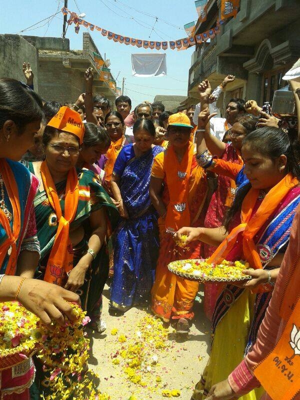 Workers of BJP's women's wing shower Anandiben with flower petals