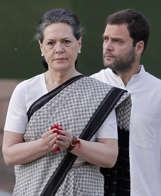 Congress president Sonia Gandhi pays tribute at her husband Rajiv Gandhi's memorial as her son lawmaker Rahul watches on the 21st anniversary of the former prime minister's death in New Delhi.