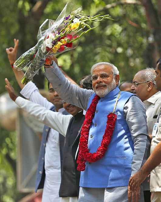 PM-designate Narendra Modi greets to supporters outside the BJP headquarters in New Delhi