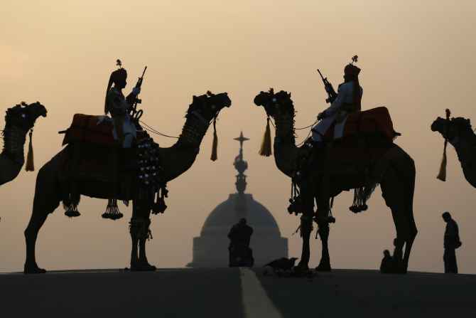 BSF soldiers ride their camels in front of Rashtrapati Bhavan during the Beating the Retreat ceremony