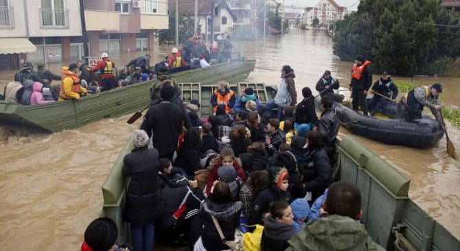 Serbian army soldiers evacuate people in amphibious vehicles in the flooded town of Obrenovac, southwest of Belgrade.