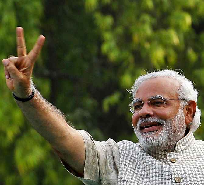 Narendra Modi waves the victory sign in Vadodara after the poll verdict was out on May 16
