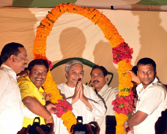BJD workers greet chief minister and BJD president Naveen Patnaik being garlanded after party swept the assembly and Lok Sabha election in Bhubaneswar.