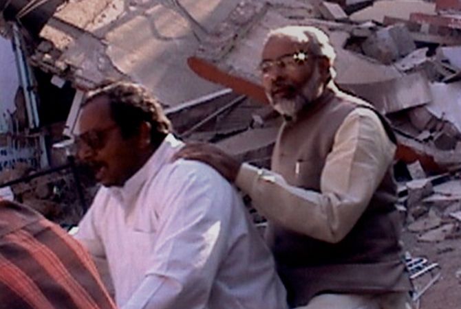 Modi on bike surveying the damage after the Gujarat earthquake.