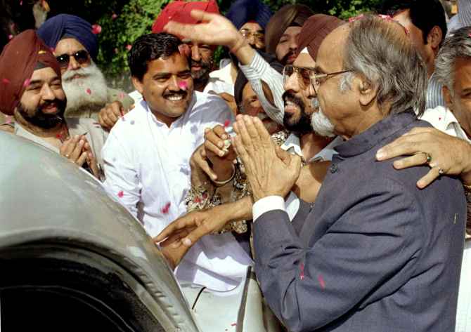 I K Gujral greets supporters on his way to his swearing in as India's 12th prime minister.