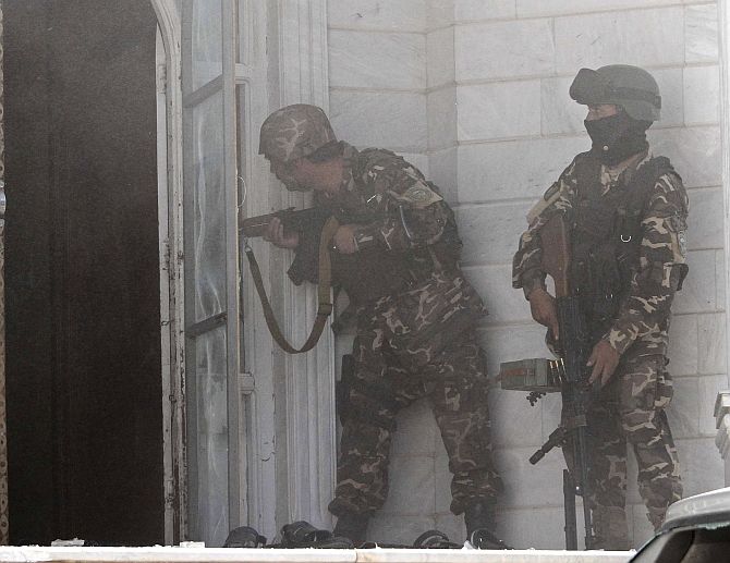 Afghan security forces take position at the scene of the May 2014 attack on the Indian consulate in Herat. 