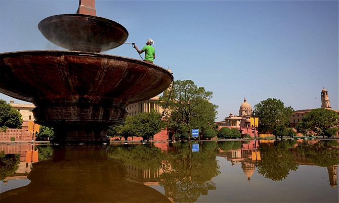 A worker busy with cleaning work near Vijay Chowk as part of preparations for the swearing-in ceremony of the new prime minister in New Delhi