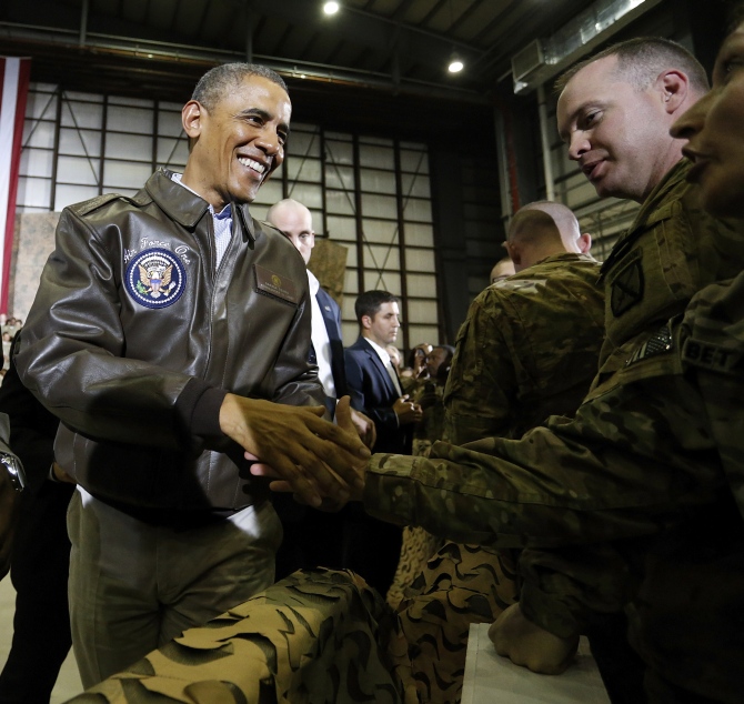 US President Barack Obama shakes hands with troops after delivering remarks at Bagram Air Base in Kabul. 