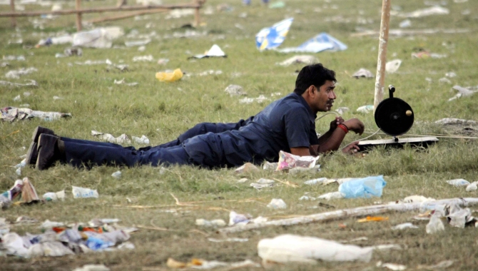 Security personnel inspect the site of a bomb blast in Patna in this picture taken on October 28, 2013.