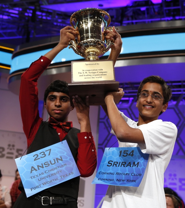 Sujoe (left) of Fort Worth, Texas and Sriram Hathwar of Painted Post, New York, hold the trophy they won in the 87th annual Scripps National Spelling Bee at National Harbor, Maryland.