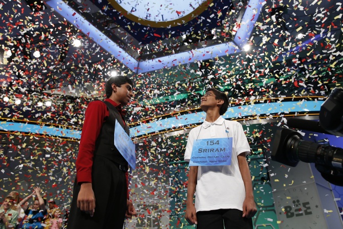 Sujoe and Hathwar look up a falling confetti upon winning the 87th annual Scripps National Spelling Bee at National Harbor, Maryland.