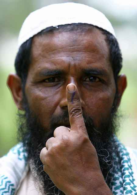 A Muslim man shows his ink-marked finger after casting his ballot in Guwahati