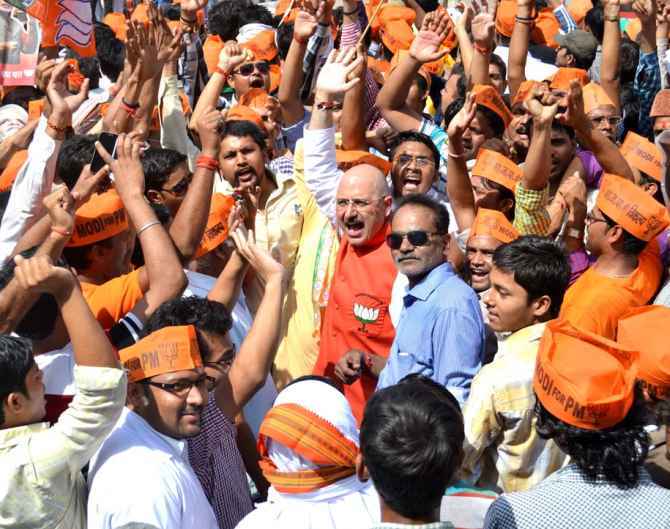 BJP supporters cheer for Narendra Modi at a roadshow in Varanasi