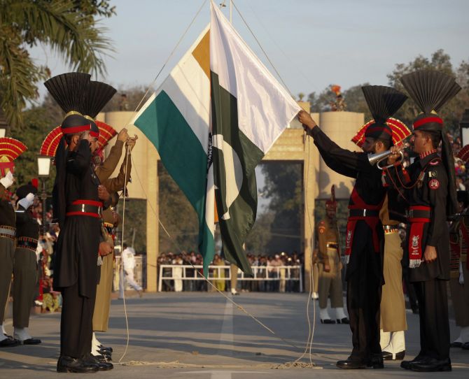 Pakistan Rangers and Indian Border Security Force personnel take part in the daily flag lowering ceremony at the joint border post of Wagah
