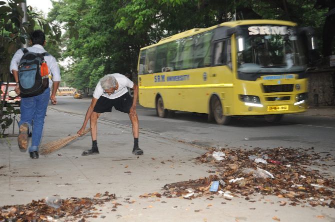 V Kalyanam cleans the road outside his home