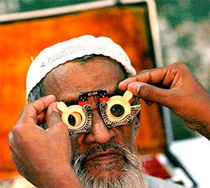 A man gets his eyes tested in a free camp.
