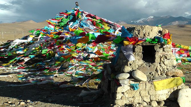Prayer mounds with flags such as this one are a common sight across Tibet. 