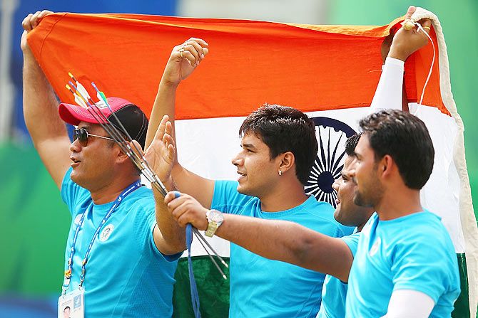 Rajat Chauhan, Sandeep Kumar and Abhishek Verma of India celebrate claiming the Gold medal in the Men's Compound Men's Team Gold Medal Match 