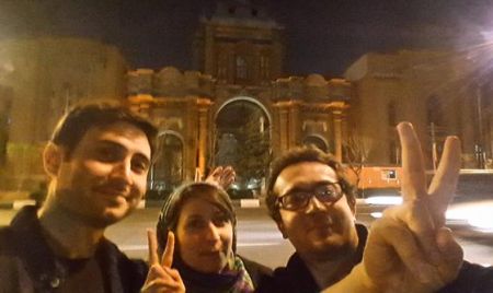 Iranians give the V-sign on the streets of Tehran following the deal with the West
