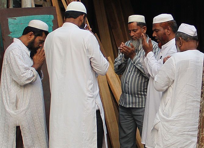 A group of Muslims in Hashimpura offer prayers. In the centre is Mohammed Naeem, one of the survivors from the 1987 massacre. Photograph: Uttam Ghosh/Rediff.com