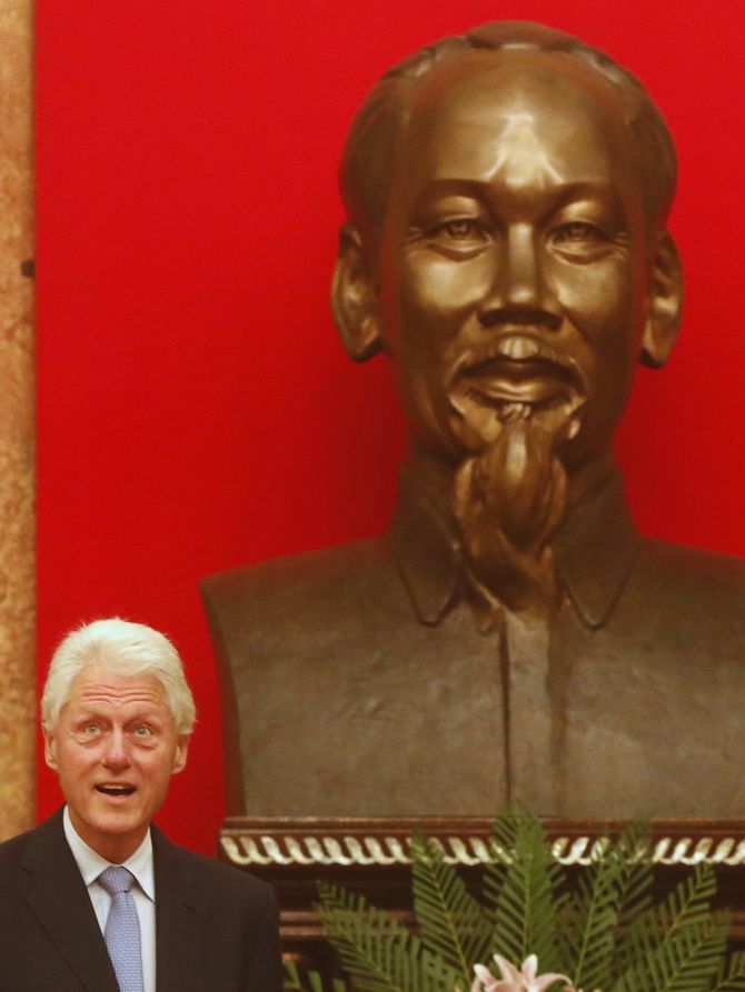 Bill Clinton with a statue of Ho Chi Minh in Hanoi