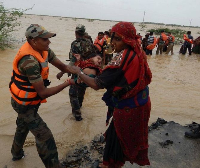 The Indian Army rescues flood hit villagers in Gujarat.