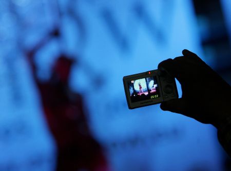 A dancer being recorded on a mobile phone