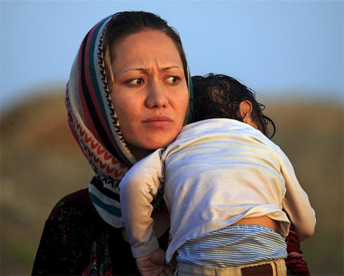 An Afghan refugee with her child after arriving in Greece.