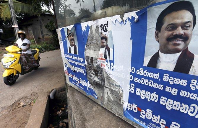  A woman rides her bike past election posters of Sri Lanka's former president Mahinda Rajapaksa in Colombo. Rajapaksa, who lost the election for the presidency in January, failed in his bid to become prime minister in the August 17, 2015 parliamentary election. Photograph: Dinuka Liyanawatte/Reuters