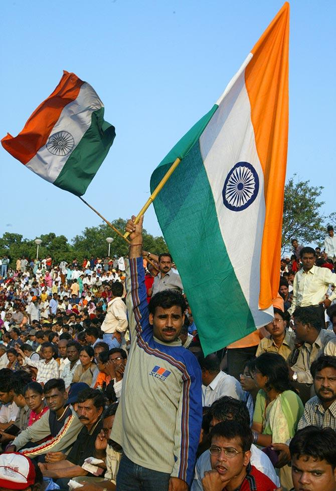 Indians raise their flag at the ceremony at Wagah border check-point.